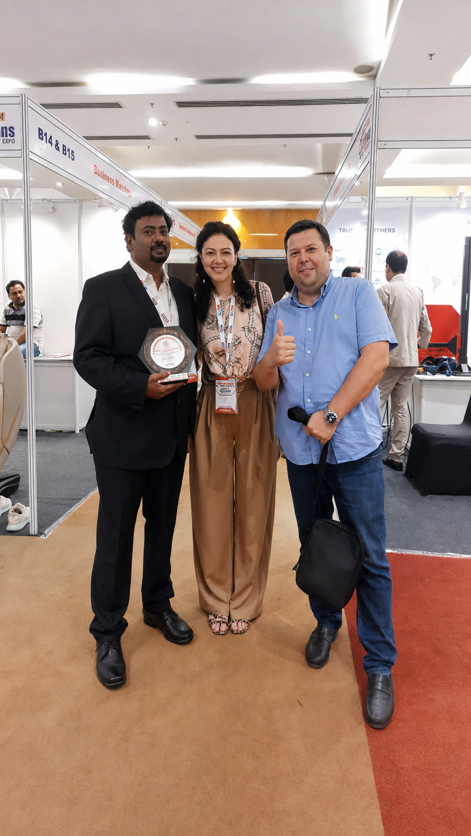Dr. V. Amudhan with industry partners at a passenger vehicle expo booth