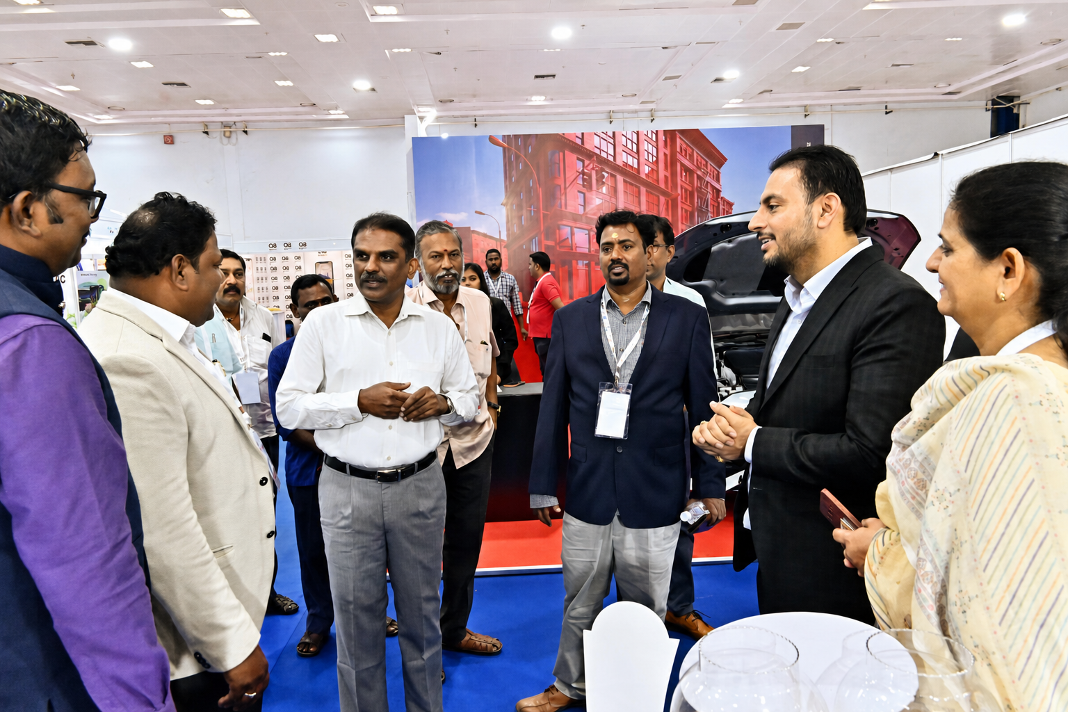 Dr. V. Amudhan in discussion with delegates at an exhibition booth